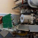 licensed technician fixing the inside of a tankless gas water heater