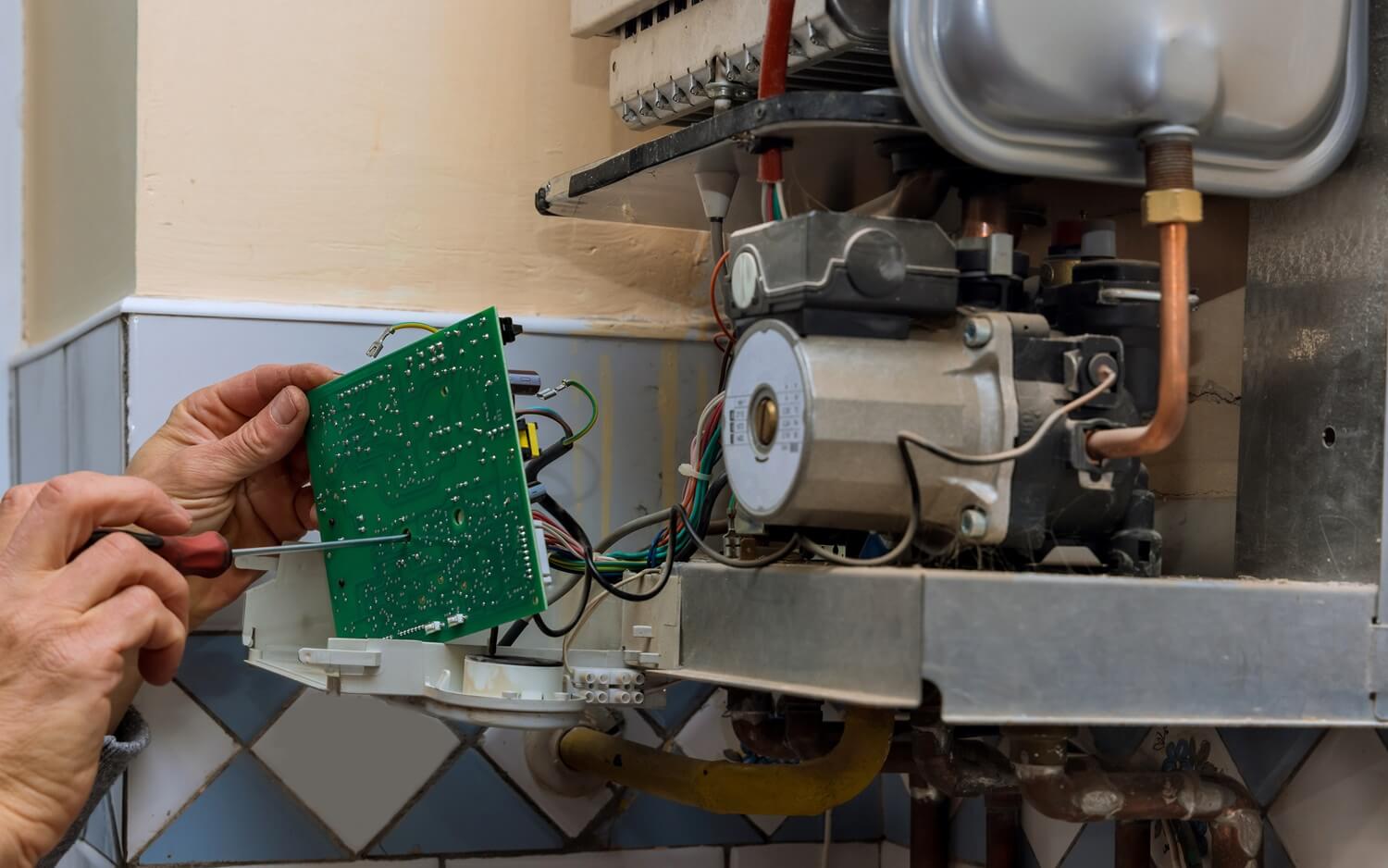 licensed technician fixing the inside of a tankless gas water heater