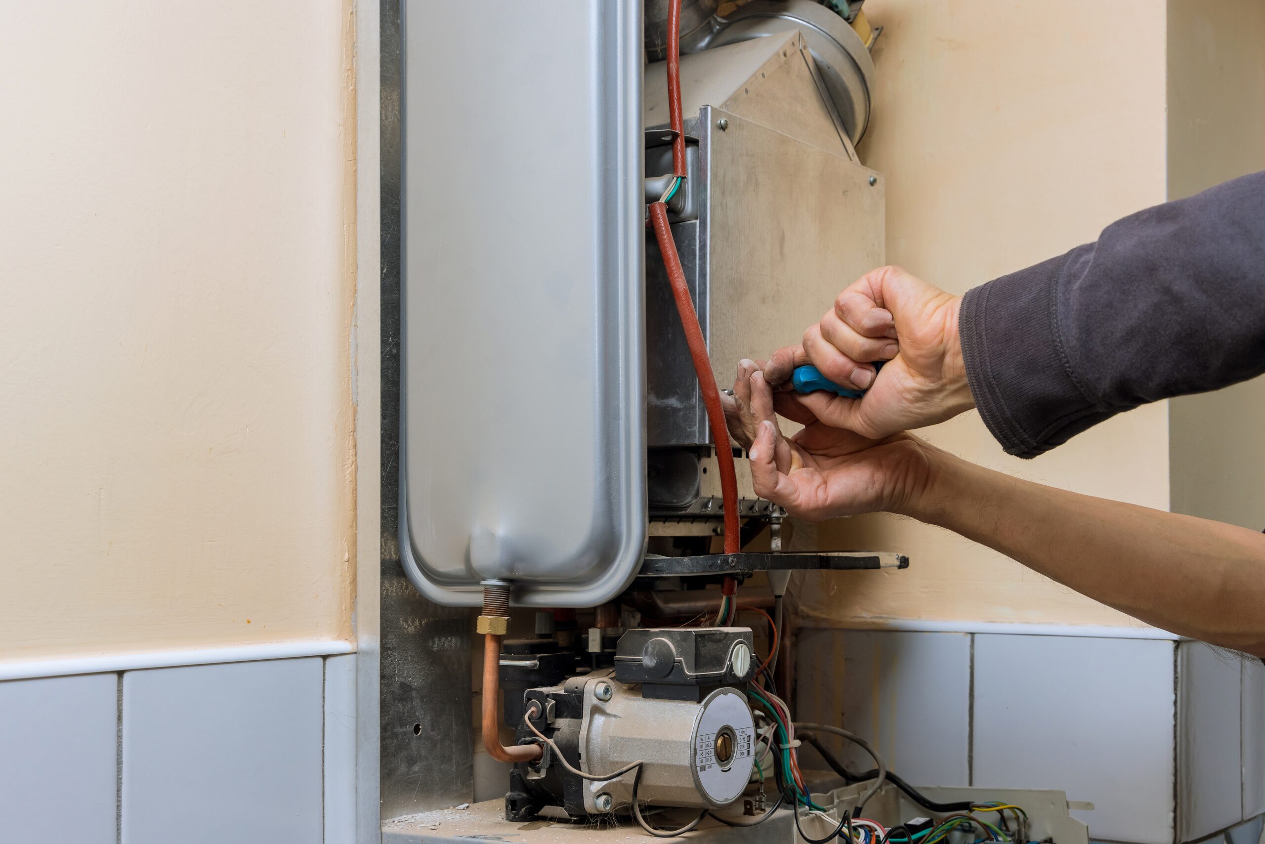 Technician repairing boiler wiring