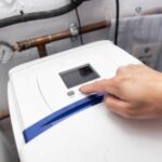 Home water softener system installed in utility room with technician checking performance levels | How Can You Tell if a Water Softener Is Working