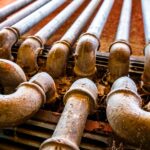 Technician replacing an underground gas line using trenchless technology with minimal excavation | How To Replace a Gas Line Without Digging