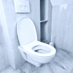 Modern bathroom with a wall-mounted toilet in a tiled space representing plumbing issues such as a gurgling toilet and drainage problems.