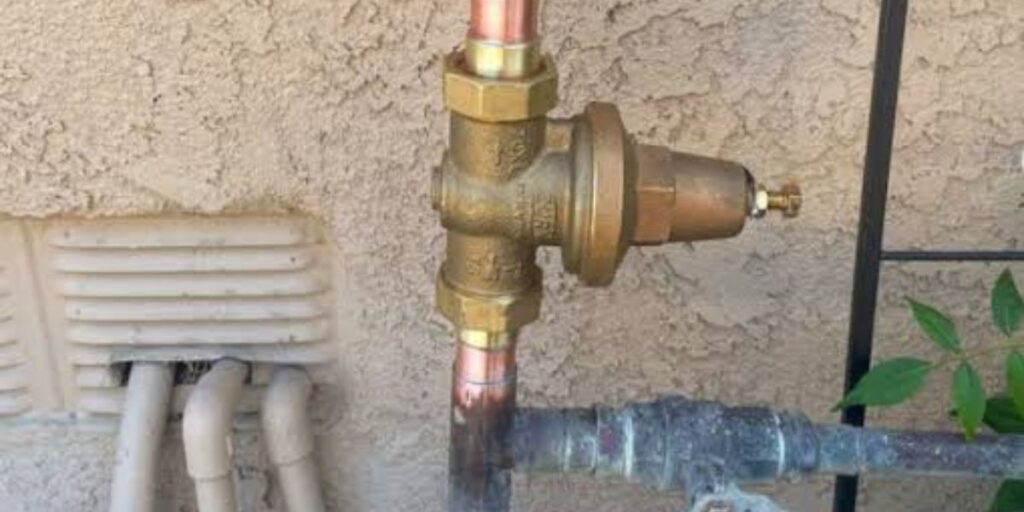 Plumber installing a water pressure regulator on a residential plumbing system | Water Pressure Regulator in Plumbing Systems