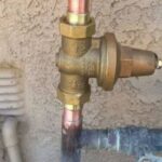 Plumber installing a water pressure regulator on a residential plumbing system | Water Pressure Regulator in Plumbing Systems